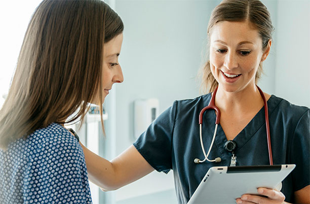 An IBS-C or CIC patient discusses her symptoms with her doctor. 