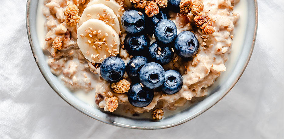 An IBS-C- and CIC-friendly bowl of blueberries, bananas, and oats. 